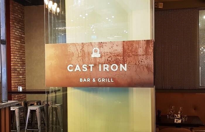 Cast Iron Bar & Grill Signage on Wood